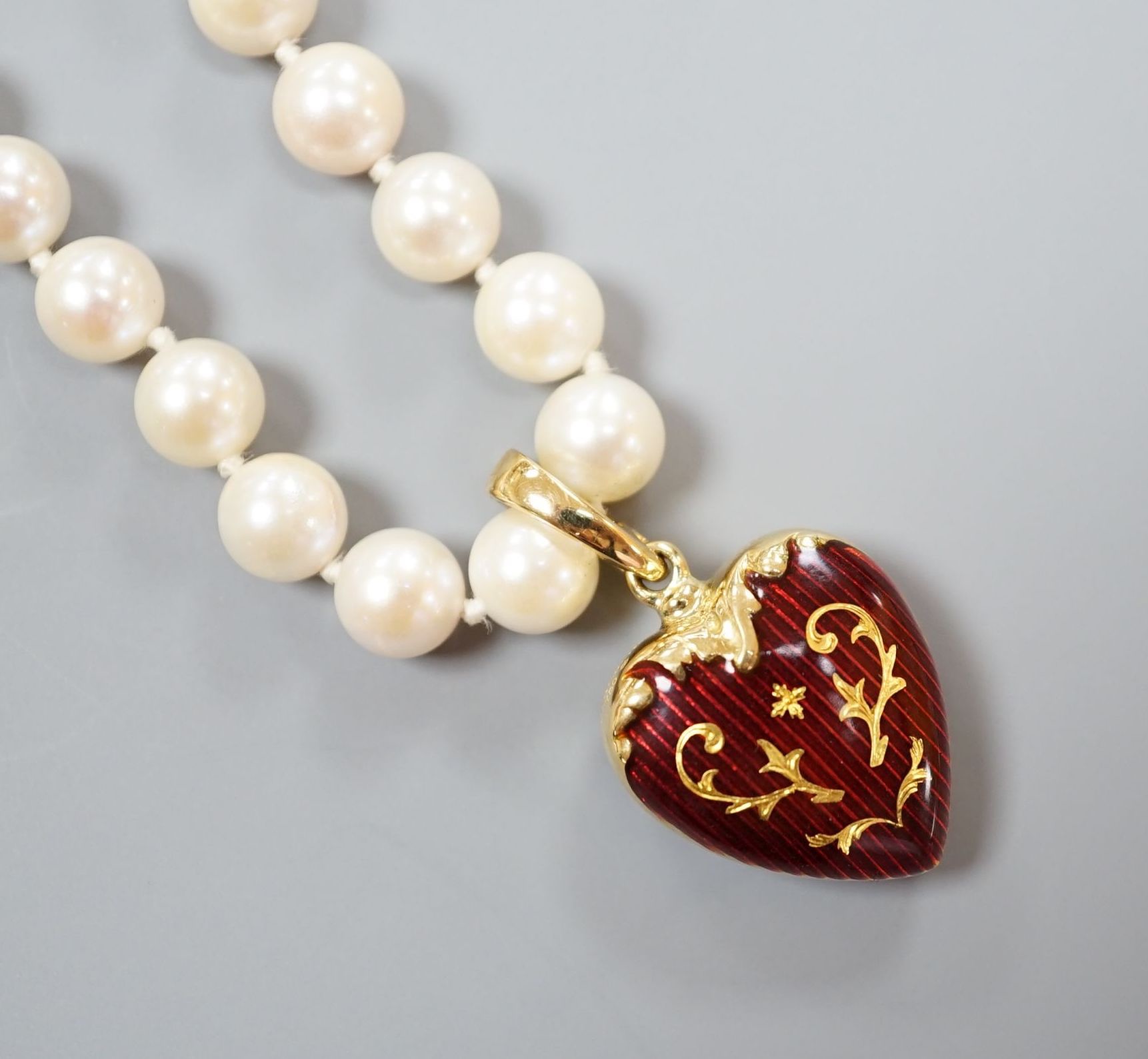 A modern Victor Mayer for Faberge 18ct gold and red guilloche enamel pendant, 19mm, on a single strand cultured pearl necklace, with 14k clasp, 50cm, gross weight 30.7 grams, with box and certificate.